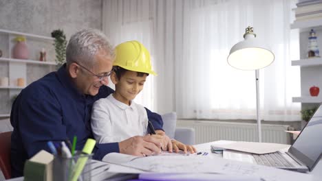Engineer-father-works-at-home-with-his-son.